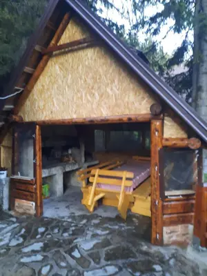 a log cabin with a bench and a roof at Vikendica Rajvosa Vlašić in Šišava