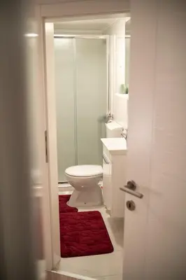 a bathroom with a toilet and a glass shower at Kuća za odmor Mali raj-Kupres in Kupres
