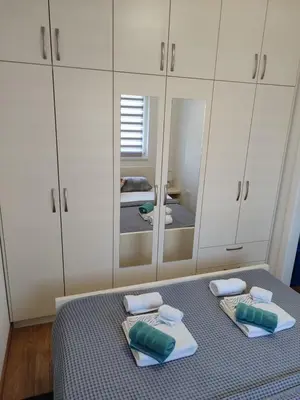 a bedroom with a bed with a large mirror at Apartman Bjanka in Banja Luka