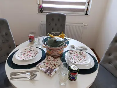 a white table with two plates of food on it at Apartman Bjanka in Banja Luka
