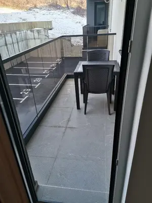 a patio with a table and chairs on a balcony at Apartment Banja Luka in Banja Luka