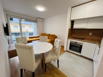 a kitchen and dining room with a table and chairs at Apartman Maja Lux in Banja Luka