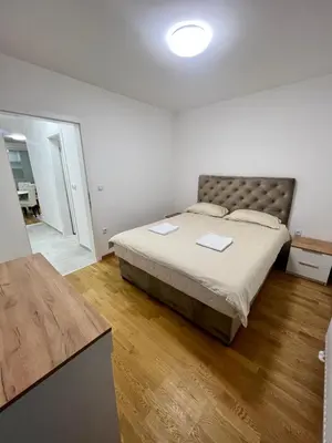 a bedroom with a large bed in a room at Apartman Maja Lux in Banja Luka