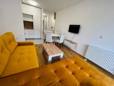 a living room with a couch and a table at Apartman Maja Lux in Banja Luka