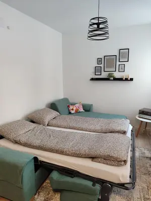 a bed sitting in a living room with at Tuzlanska Panonica in Tuzla