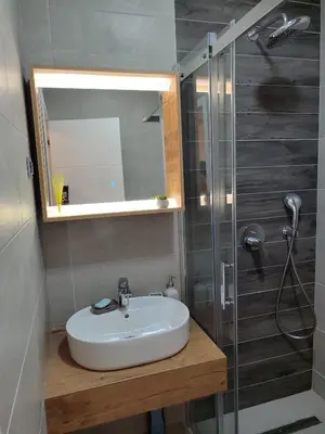 a bathroom with a sink and a shower at Tuzlanska Panonica in Tuzla
