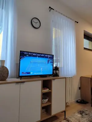 a flat screen tv sitting on top of a cabinet at Tuzlanska Panonica in Tuzla