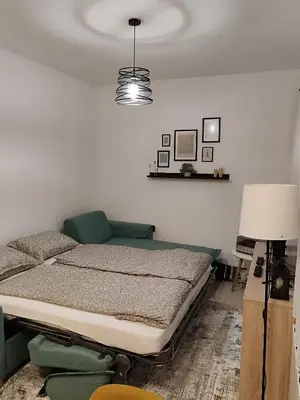 a bedroom with a bed and a lamp at Panonika Tuzla in Tuzla