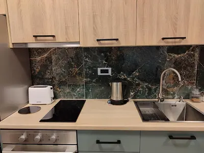 a kitchen with a sink and a counter top at Panonika Tuzla in Tuzla