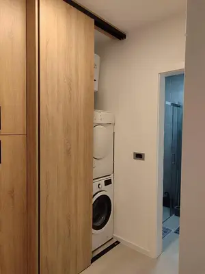a laundry room with a washer and dryer at Panonika Tuzla in Tuzla