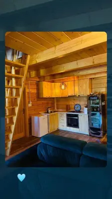 a small kitchen with a staircase in a cabin at Vikendica Bajka in Banja Luka