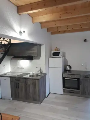 a kitchen with a sink and a white refrigerator at Vikendica Striček in Kupres