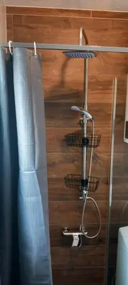 a room with a shower curtain and three shopping baskets at Vikendica Striček in Kupres