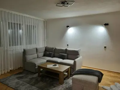 a living room with a couch and a table at Apartment Urban Nest in Zenica