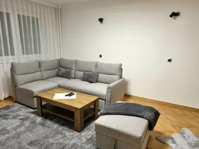 a living room with a couch and a coffee table at Apartment Urban Nest in Zenica