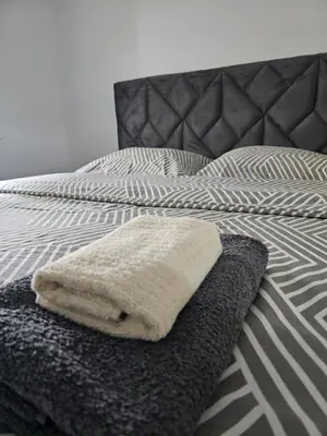 a bed with two towels sitting on it at Apartman Urukalo in Rebrovac