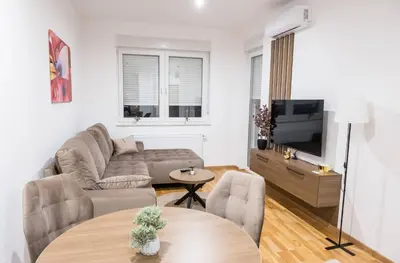 a living room with a couch and a tv at Ada Nostra in Banja Luka
