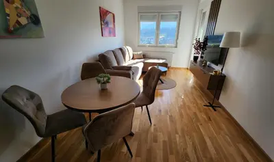 a living room with a table and a couch at Ada Nostra in Banja Luka