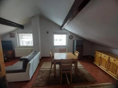 a living room with a table and a couch at Apartmani Ivan in Kupres
