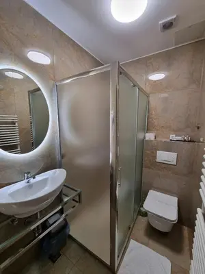 a bathroom with a shower and a sink and a toilet at Motel Bor in Vitez