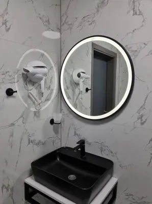 a bathroom with a black sink and a mirror at Motel Bor in Vitez