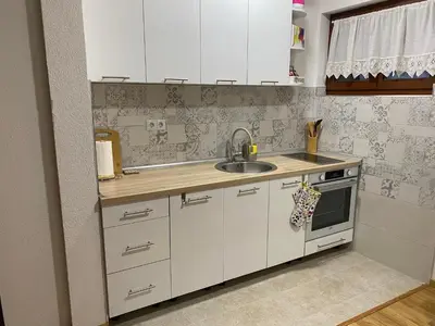 a kitchen with white cabinets and a sink at Villa Ruža Vareš in Vareš