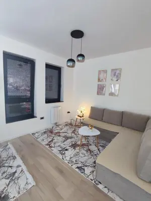 a living room with a couch and a table at AS apartman Panonica in Tuzla