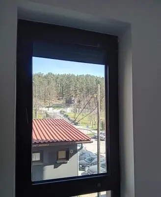 a window with a view of a parking lot at AS apartman Panonica in Tuzla