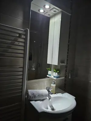 a bathroom with a white sink and a mirror at Mrakovica 1 in Prijedor