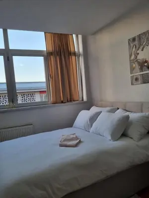a bedroom with a large white bed with a window at Mrakovica 1 in Prijedor