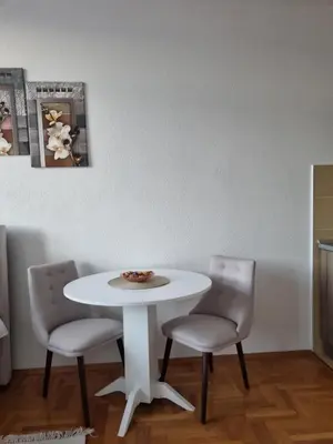 a white table and two chairs in a room at Mrakovica 1 in Prijedor