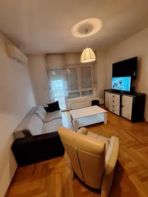 a living room with a couch and a table at San apartment in Banja Luka