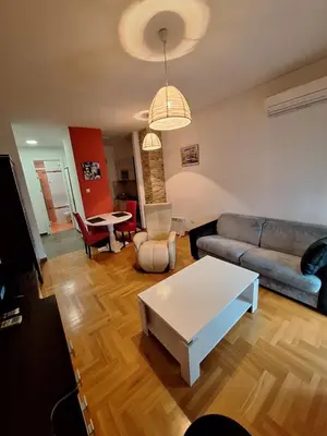 a living room with a couch and a table at San apartment in Banja Luka