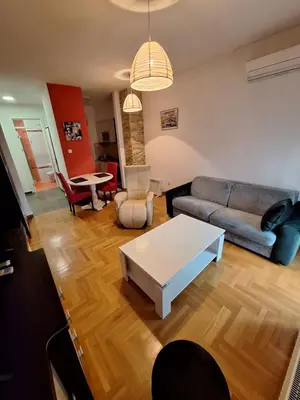 a living room with a couch and a table at San apartment in Banja Luka