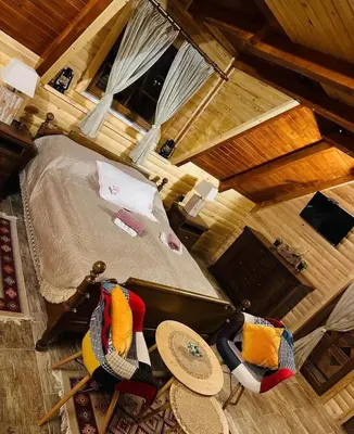 an overhead view of a bedroom with a bed and chairs at Planinska kuća Mali Raj in Mrkonjić Grad