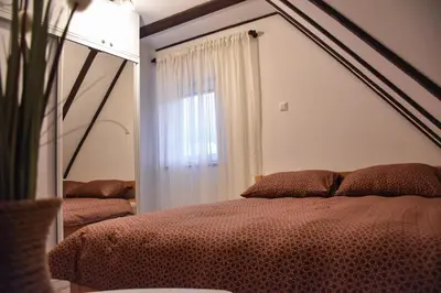 a bedroom with a bed with a large mirror at Villa Šola in Kupres