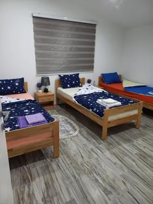 a bedroom with two beds and a window in it at Apartman Varcar in Bihać