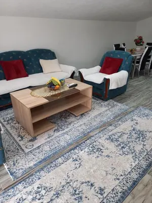 a living room with a couch and a coffee table at Apartman Varcar in Bihać