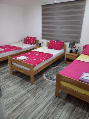 a room with two beds and a couch at Apartman Varcar in Bihać