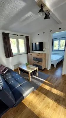 a living room with a couch and a table at Unatime.Krupa in Bosanska Krupa