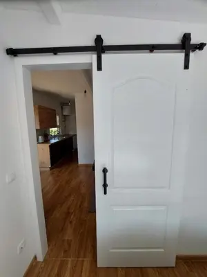 a sliding barn door in a living room at Unatime.Krupa in Bosanska Krupa