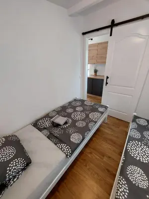 a room with a bed in a room with a door at Unatime.Krupa in Bosanska Krupa