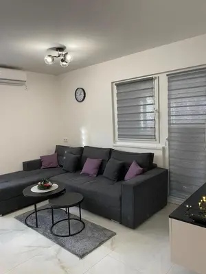 a living room with a couch and a table at Apartman Marina stan na dan in Prijedor