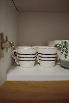 three cups sitting on top of a shelf at 5 min Apartment in Banja Luka