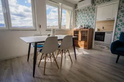a kitchen and dining room with a table and chairs at 5 min Apartment in Banja Luka