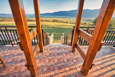 a wooden stairway leading to a balcony with a view at Vikendica Ivana in Livno
