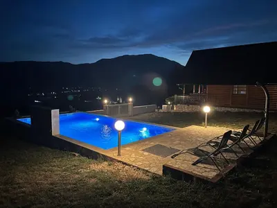 a swimming pool in a yard at night at Vikendica Ivana in Livno