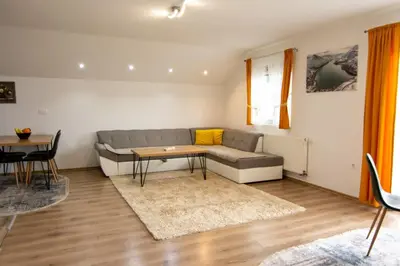 a living room with a couch and a table at Villa Pliva Lake in Jajce