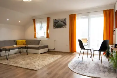 a living room with a couch and a table and chairs at Villa Pliva Lake in Jajce