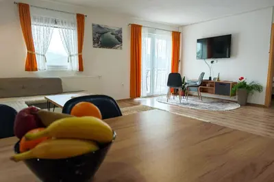 a living room with a bowl of fruit on a table at Villa Pliva Lake in Jajce